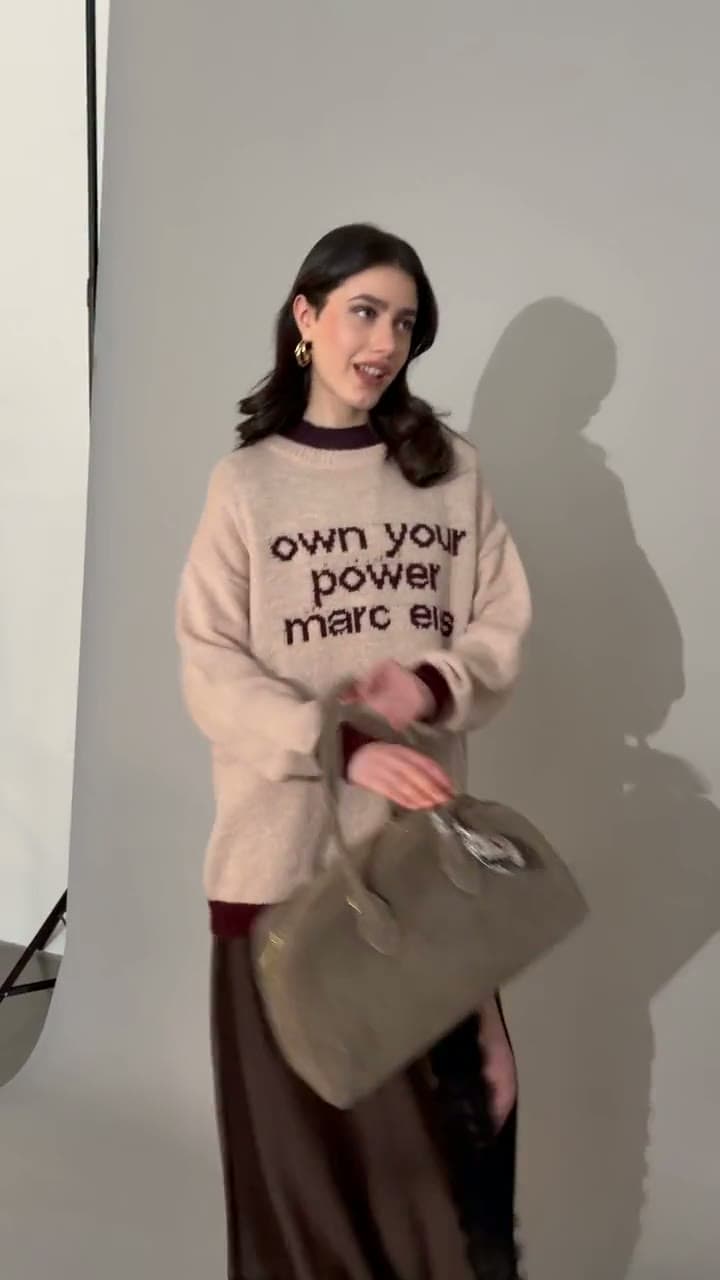 Marc Ellis — backstage dello shooting FW26-27: maglione «own your power» e borsa